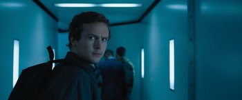 Movie still from “Escape Room: Tournament of Champions” (2021), directed by Adam Robitel – A man standing next to a wall in a dark room; Close Up shot, Over the shoulder angle