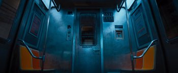 Movie still from “Escape Room: Tournament of Champions” (2021), directed by Adam Robitel – A train car with a door open at night time; Wide shot, High angle