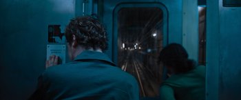 Movie still from “Escape Room: Tournament of Champions” (2021), directed by Adam Robitel – A man and a woman on a train at night; Medium shot, Over the shoulder angle