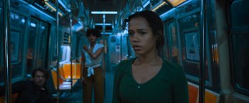 Movie still from “Escape Room: Tournament of Champions” (2021), directed by Adam Robitel – A woman standing on a train next to another woman; Medium shot, Over the shoulder angle