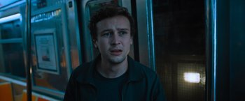 Movie still from “Escape Room: Tournament of Champions” (2021), directed by Adam Robitel – A young man is crying while standing in front of a train; Close Up shot, Low angle