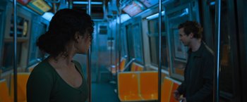 Movie still from “Escape Room: Tournament of Champions” (2021), directed by Adam Robitel – A woman standing on a train looking out the train window; Medium shot, Over the shoulder angle