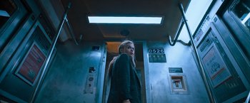 Movie still from “Escape Room: Tournament of Champions” (2021), directed by Adam Robitel – A woman standing in front of a door way; Medium shot, Low angle