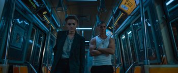 Movie still from “Escape Room: Tournament of Champions” (2021), directed by Adam Robitel – A man and a woman are standing on a bus; Medium shot, Low angle