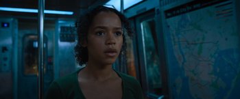 Movie still from “Escape Room: Tournament of Champions” (2021), directed by Adam Robitel – A young woman standing on a train platform; Close Up shot, Low angle