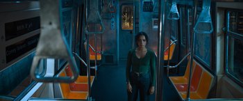 Movie still from “Escape Room: Tournament of Champions” (2021), directed by Adam Robitel – A woman standing on a train looking at the camera; Medium shot, High angle