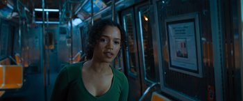 Movie still from “Escape Room: Tournament of Champions” (2021), directed by Adam Robitel – A woman in a green shirt standing on a train platform; Close Up shot, Low angle