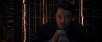 Movie still from “Escape Room: Tournament of Champions” (2021), directed by Adam Robitel – A person sitting in a dark room; Close Up shot, Low angle