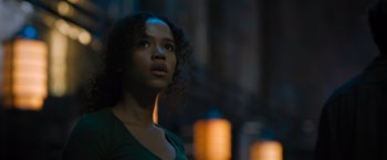 Movie still from “Escape Room: Tournament of Champions” (2021), directed by Adam Robitel – A woman with curly hair is looking up at the sky; Close Up shot, Low angle