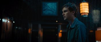 Movie still from “Escape Room: Tournament of Champions” (2021), directed by Adam Robitel – A man standing in front of a painting in a dark room; Close Up shot, Low angle