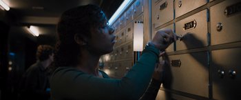 Movie still from “Escape Room: Tournament of Champions” (2021), directed by Adam Robitel – A woman is looking into a filing cabinet; Close Up shot, Low angle