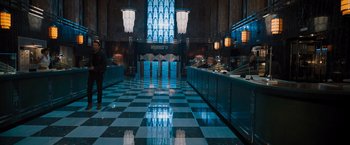 Movie still from “Escape Room: Tournament of Champions” (2021), directed by Adam Robitel – A lobby with a checkerboard floor and a stained - glass window; Extreme Wide shot, High angle