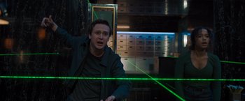 Movie still from “Escape Room: Tournament of Champions” (2021), directed by Adam Robitel – A man in a room with green lights on the wall; Medium shot, Low angle