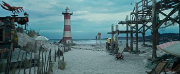 Movie still from “Escape Room: Tournament of Champions” (2021), directed by Adam Robitel – A lighthouse on the beach with a red and white striped tower; Extreme Wide shot, High angle