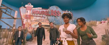 Movie still from “Escape Room: Tournament of Champions” (2021), directed by Adam Robitel – A group of people walking in front of a sign; Medium shot, Low angle