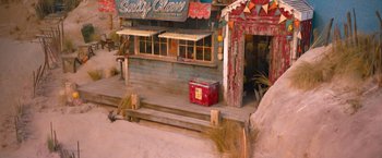 Movie still from “Escape Room: Tournament of Champions” (2021), directed by Adam Robitel – An old fashioned ice chest sitting on top of a wooden deck; Extreme Wide shot, High angle
