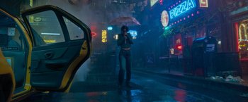Movie still from “Escape Room: Tournament of Champions” (2021), directed by Adam Robitel – A woman standing in the rain holding an umbrella; Wide shot, Low angle