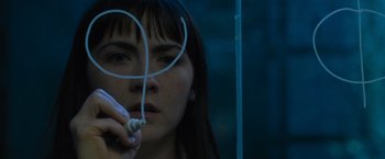 Movie still from “Escape Room: Tournament of Champions” (2021), directed by Adam Robitel – A woman is holding a pair of headphones in front of her face; Close Up shot, Overhead angle