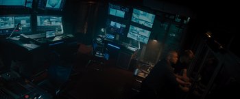 Movie still from “Escape Room: Tournament of Champions” (2021), directed by Adam Robitel – A dark room with a desk and a computer monitor; Extreme Wide shot, High angle