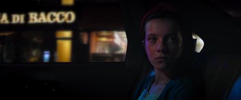 Movie still from “Escape Room: Tournament of Champions” (2021), directed by Adam Robitel – A woman sitting in the back of a car at night; Close Up shot, Over the shoulder angle