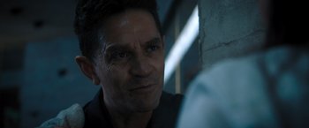 Movie still from “Escape Room: Tournament of Champions” (2021), directed by Adam Robitel – A man's face in a dark room; Close Up shot, Over the shoulder angle