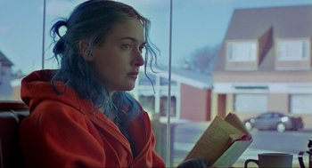 Movie still from “Eternal Sunshine of the Spotless Mind” (2004), directed by Michel Gondry – A woman sitting in front of a window reading a book; Close Up shot, Over the shoulder angle