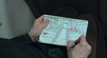 Movie still from “Eternal Sunshine of the Spotless Mind” (2004), directed by Michel Gondry – A person holding a notebook with a drawing of a train; Extreme Close Up shot, Overhead angle