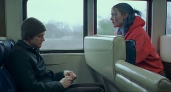Movie still from “Eternal Sunshine of the Spotless Mind” (2004), directed by Michel Gondry – A man and a woman sitting on a train; Medium shot, Over the shoulder angle