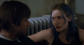 Movie still from “Eternal Sunshine of the Spotless Mind” (2004), directed by Michel Gondry – A woman sitting next to a man in a room; Close Up shot, Over the shoulder angle
