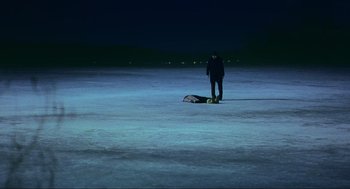 Movie still from “Eternal Sunshine of the Spotless Mind” (2004), directed by Michel Gondry – A man standing in the middle of an open field at night; Extreme Wide shot, High angle