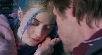Movie still from “Eternal Sunshine of the Spotless Mind” (2004), directed by Michel Gondry – A man and a woman with blue hair looking at each other; Close Up shot, Over the shoulder angle