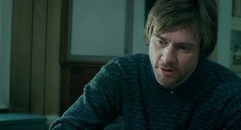 Movie still from “Eternal Sunshine of the Spotless Mind” (2004), directed by Michel Gondry – A person sitting at a table; Close Up shot, Over the shoulder angle