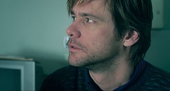 Movie still from “Eternal Sunshine of the Spotless Mind” (2004), directed by Michel Gondry – A person wearing a sweater with a cigarette in his mouth; Close Up shot, Over the shoulder angle