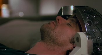 Movie still from “Eternal Sunshine of the Spotless Mind” (2004), directed by Michel Gondry – A person laying down with his eyes closed; Close Up shot, High angle