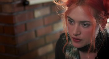 Movie still from “Eternal Sunshine of the Spotless Mind” (2004), directed by Michel Gondry – A person with pink hair; Close Up shot, Over the shoulder angle
