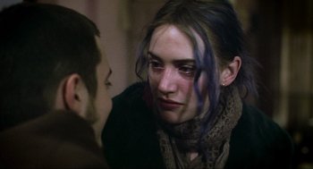 Movie still from “Eternal Sunshine of the Spotless Mind” (2004), directed by Michel Gondry – A young woman with blue hair looking at a young man; Close Up shot, Over the shoulder angle
