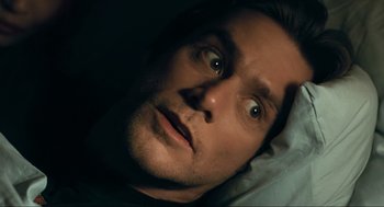 Movie still from “Eternal Sunshine of the Spotless Mind” (2004), directed by Michel Gondry – A person laying in a bed; Close Up shot, High angle