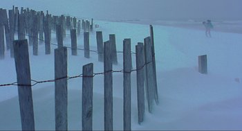 Movie still from “Eternal Sunshine of the Spotless Mind” (2004), directed by Michel Gondry – A wooden fence in the middle of a snow covered field; Extreme Wide shot, High angle