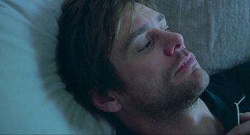Movie still from “Eternal Sunshine of the Spotless Mind” (2004), directed by Michel Gondry – A person laying in a bed; Close Up shot, Overhead angle