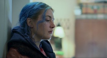 Movie still from “Eternal Sunshine of the Spotless Mind” (2004), directed by Michel Gondry – A woman with blue hair is looking to her left; Close Up shot, Over the shoulder angle