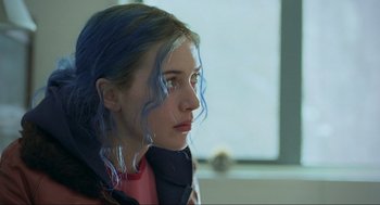Movie still from “Eternal Sunshine of the Spotless Mind” (2004), directed by Michel Gondry – A woman with blue hair looking to her left; Close Up shot, Over the shoulder angle
