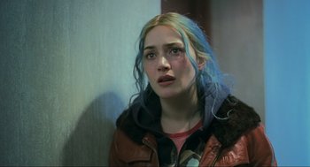 Movie still from “Eternal Sunshine of the Spotless Mind” (2004), directed by Michel Gondry – A woman with blue hair is looking into the distance; Close Up shot, Over the shoulder angle