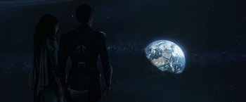 Movie still from “Eternals” (2021), directed by Chloé Zhao – A man standing in front of the earth in space; Extreme Wide shot, Over the shoulder angle