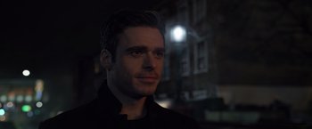 Movie still from “Eternals” (2021), directed by Chloé Zhao – A person wearing a black shirt; Close Up shot, Over the shoulder angle