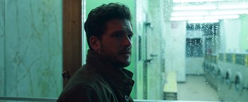 Movie still from “Eternals” (2021), directed by Chloé Zhao – A person looking out of a window; Close Up shot, Low angle