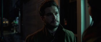 Movie still from “Eternals” (2021), directed by Chloé Zhao – A person wearing a jacket; Close Up shot, Over the shoulder angle