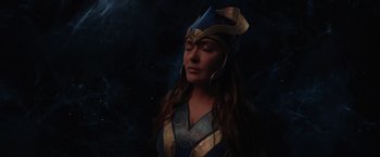 Movie still from “Eternals” (2021), directed by Chloé Zhao – A woman wearing a blue and gold costume; Close Up shot, High angle