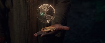 Movie still from “Eternals” (2021), directed by Chloé Zhao – A person holding a globe in their hand; Extreme Close Up shot, High angle