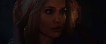 Movie still from “Eternals” (2021), directed by Chloé Zhao – A woman's face in the dark; Extreme Close Up shot, Over the shoulder angle