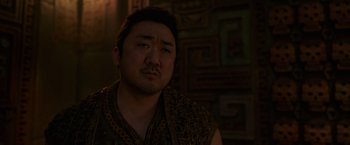 Movie still from “Eternals” (2021), directed by Chloé Zhao – A person wearing a vest; Close Up shot, Over the shoulder angle